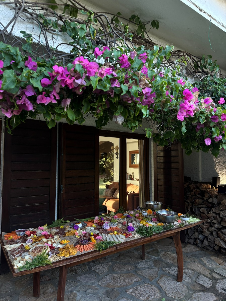 A grazing table set beneath cascading bougainvillea at a Lisbon villa