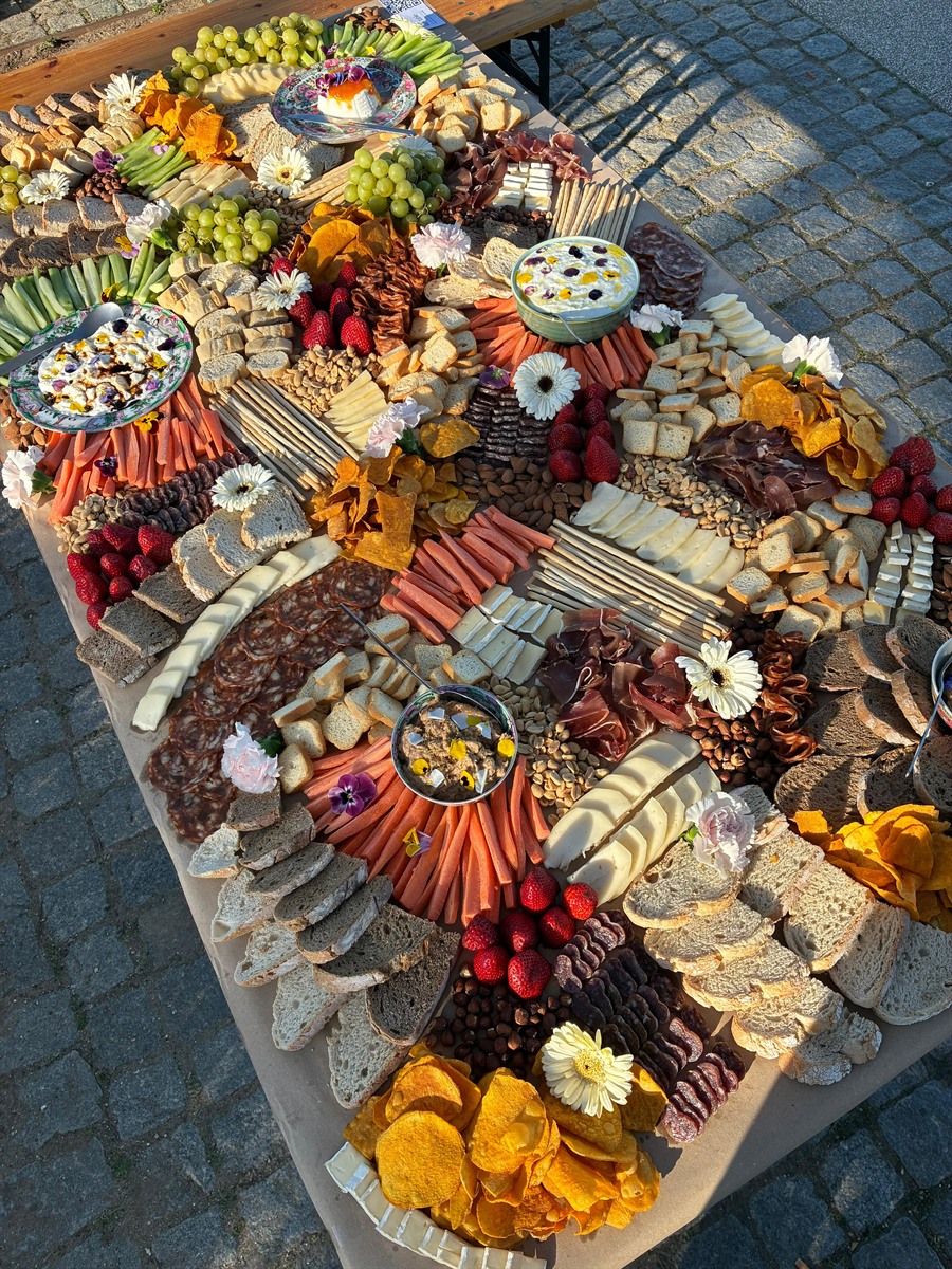 Overhead view of a richly styled, colourful grazing table